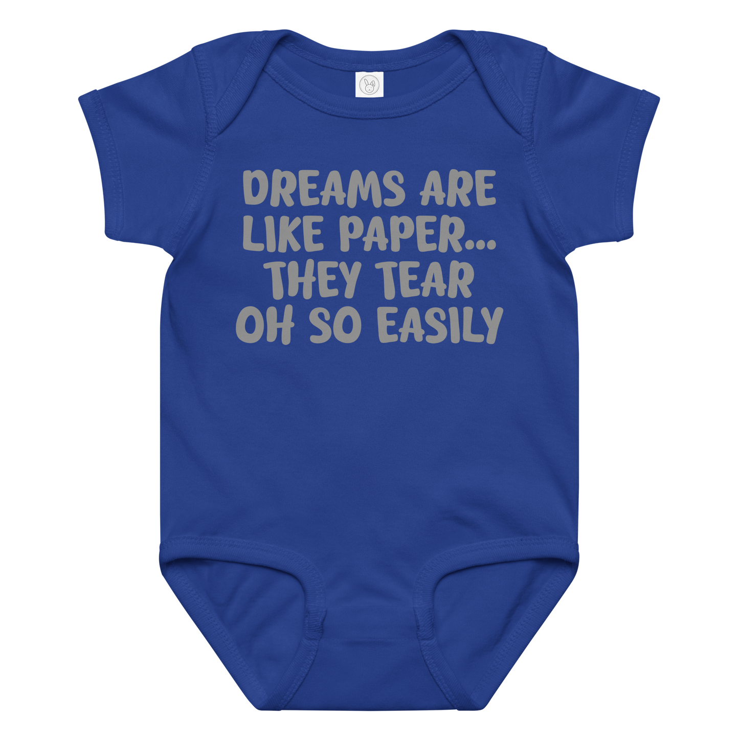 "Dreams are like paper, they tear oh so easily" printed on a royal baby jersey bodysuit laying on a flat surface amongst other clothes