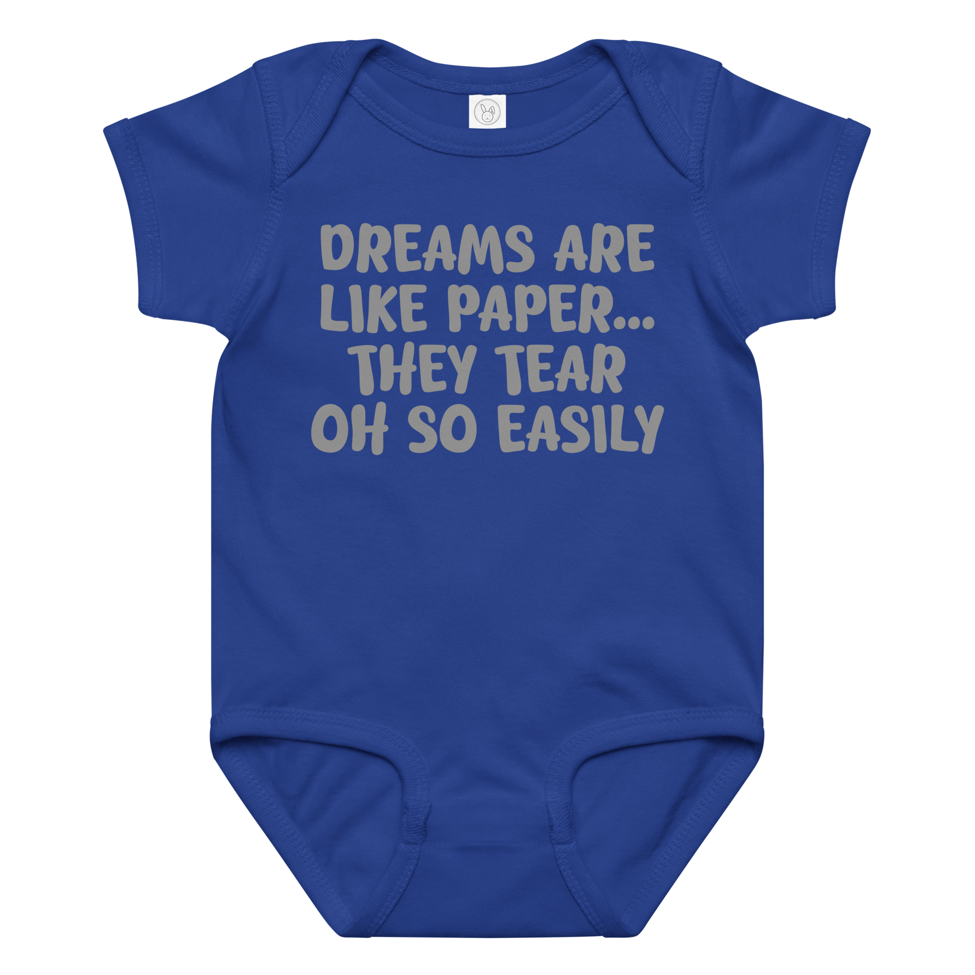 "Dreams are like paper, they tear oh so easily" printed on a royal baby jersey bodysuit laying on a flat surface amongst other clothes