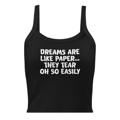 "Dreams are like paper, they tear oh so easily" printed on a solid black blend women's micro-rib tanktop laying on a flat surface