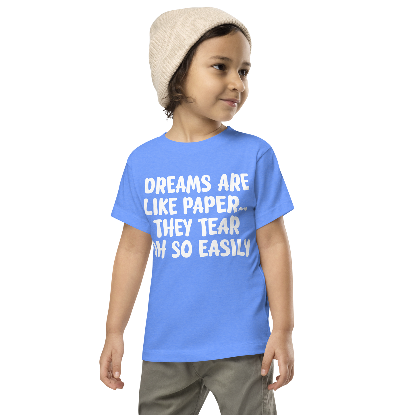 "Dreams are like paper, they tear oh so easily" printed on a heather columbia blue toddler short sleeve tee worn by a male wearing a cap