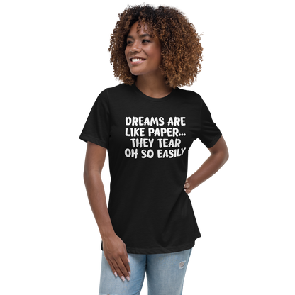 "Dreams are like paper, they tear oh so easily" printed on a black women's relaxed t-shirt worn by a female