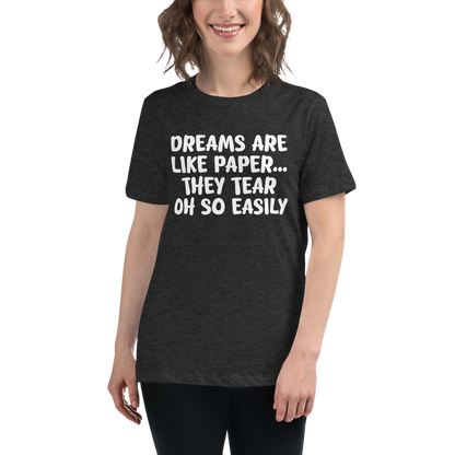 "Dreams are like paper, they tear oh so easily" printed on a dark grey heather women's relaxed t-shirt worn by a female