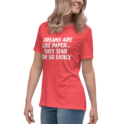 "Dreams are like paper, they tear oh so easily" printed on a heather red women's relaxed t-shirt worn by a female