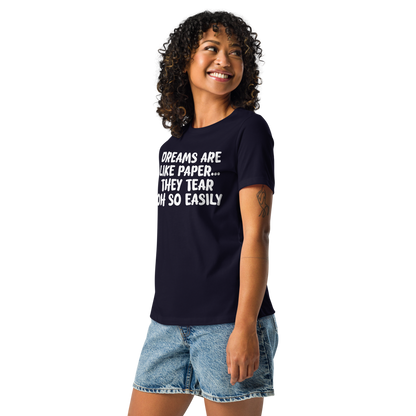 "Dreams are like paper, they tear oh so easily" printed on a navy women's relaxed t-shirt worn by a female