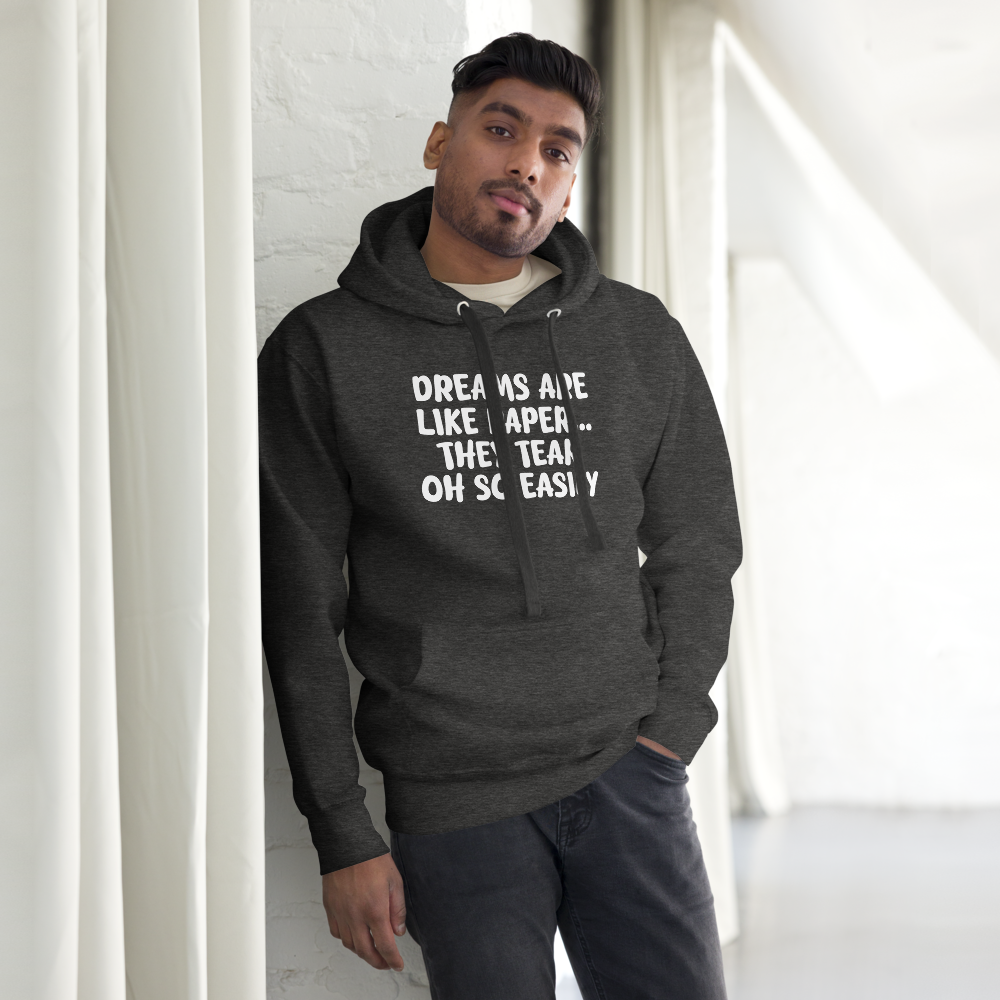 "Dreams are like paper, they tear oh so easily" printed on a charcoal heather unisex hoodie worn by a male