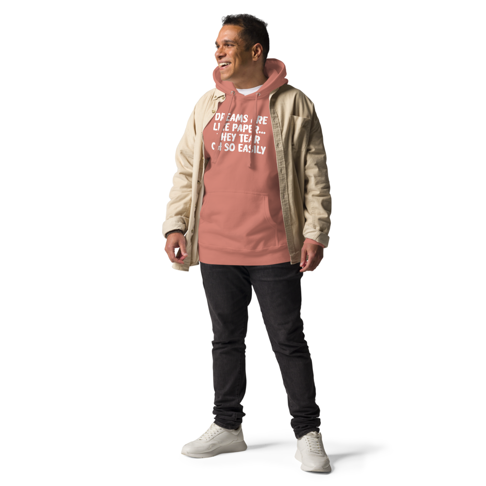 "Dreams are like paper, they tear oh so easily" printed on a dusty rose unisex hoodie worn by a male with a jacket on top