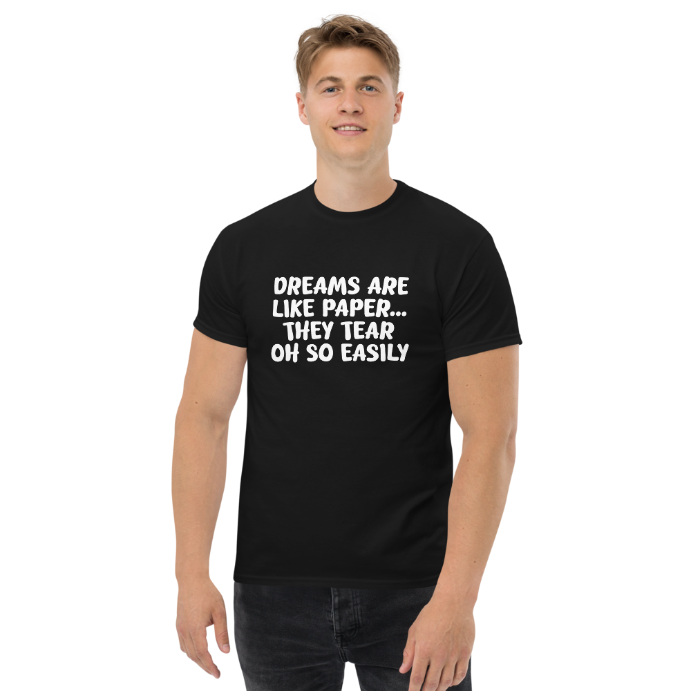 "Dreams are like paper, they tear oh so easily" printed on a black unisex classic tee worn by a male