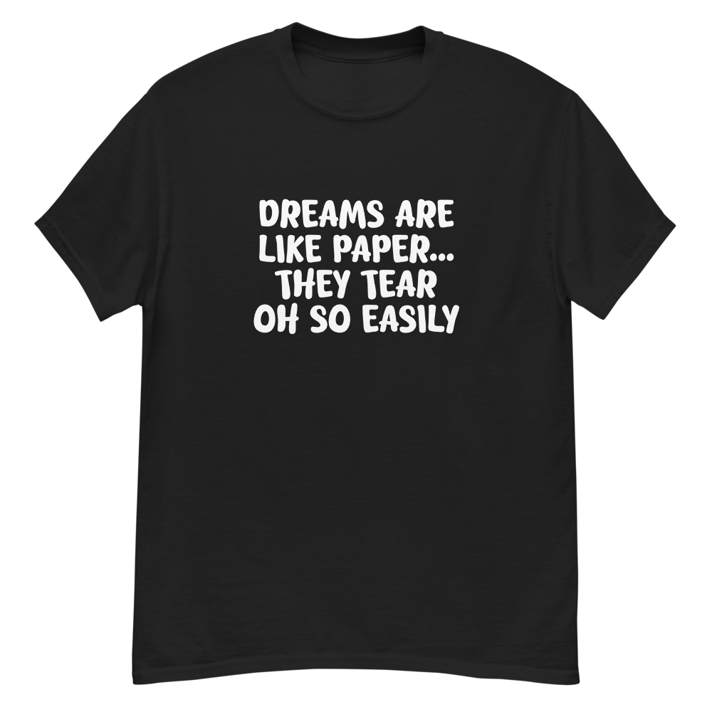 "Dreams are like paper, they tear oh so easily" printed on a black unisex classic tee laying on a flat surface