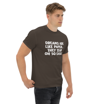 "Dreams are like paper, they tear oh so easily" printed on a dark chocolate unisex classic tee worn by a male