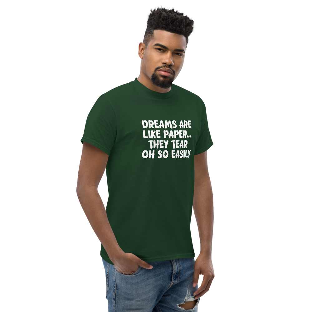 "Dreams are like paper, they tear oh so easily" printed on a forest green unisex classic tee worn by a male