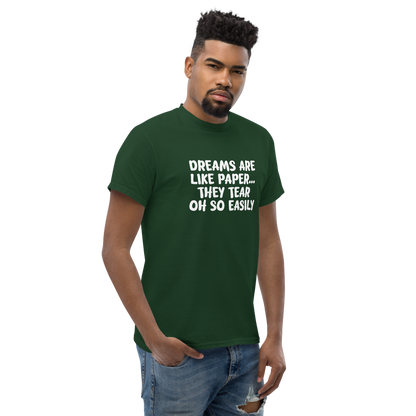 "Dreams are like paper, they tear oh so easily" printed on a forest green unisex classic tee worn by a male