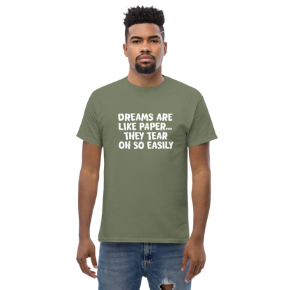 "Dreams are like paper, they tear oh so easily" printed on a military green unisex classic tee worn by a male