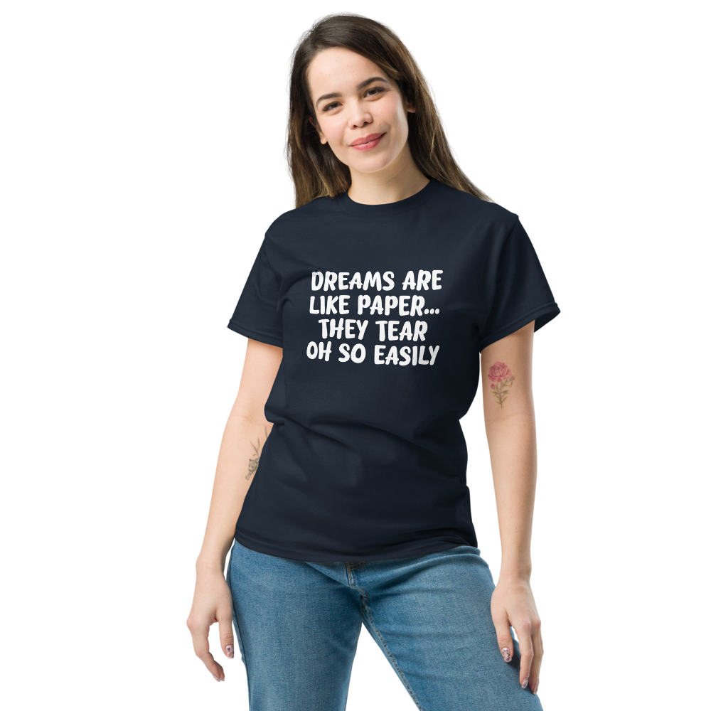 "Dreams are like paper, they tear oh so easily" printed on a navy unisex classic tee worn by a female