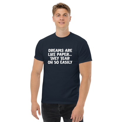 "Dreams are like paper, they tear oh so easily" printed on a navy unisex classic tee worn by a male