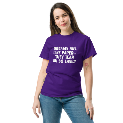 "Dreams are like paper, they tear oh so easily" printed on a purple unisex classic tee worn by a female