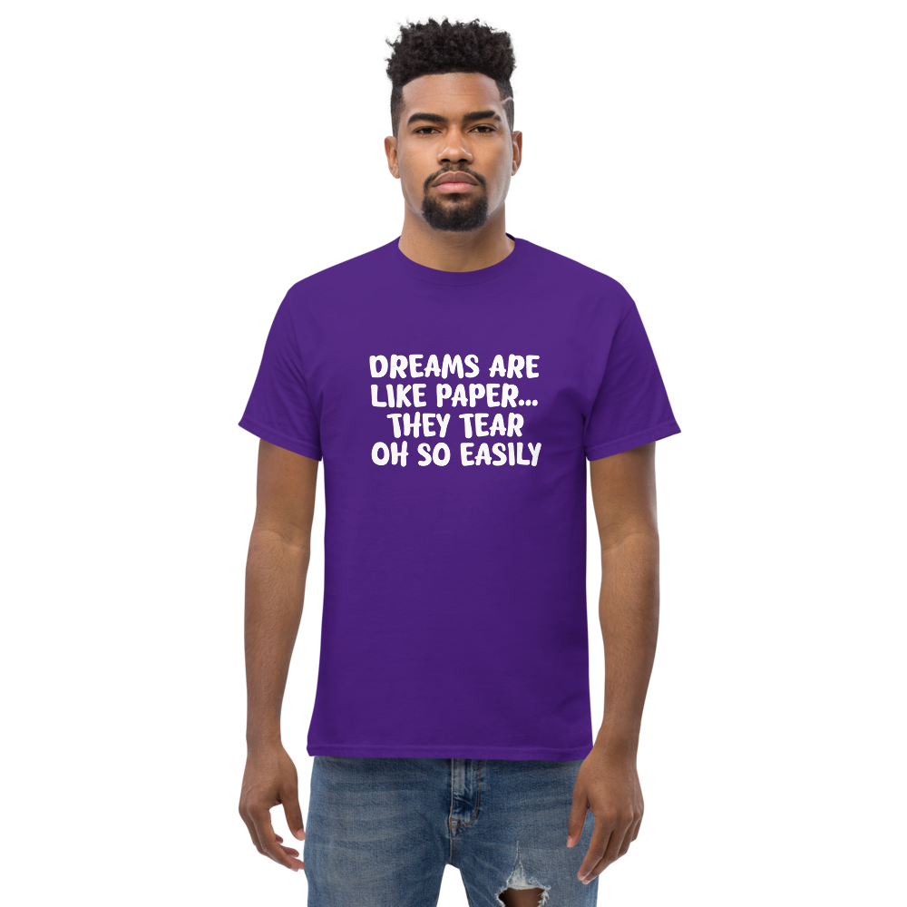 "Dreams are like paper, they tear oh so easily" printed on a purple unisex classic tee worn by a male