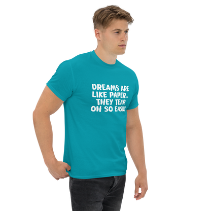 "Dreams are like paper, they tear oh so easily" printed on a tropical blue unisex classic tee worn by a male