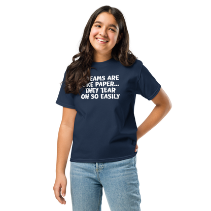 "Dreams are like paper, they tear oh so easily" printed on a navy youth classic tee worn by a female