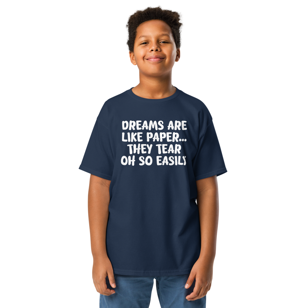 "Dreams are like paper, they tear oh so easily" printed on a navy youth classic tee worn by a male