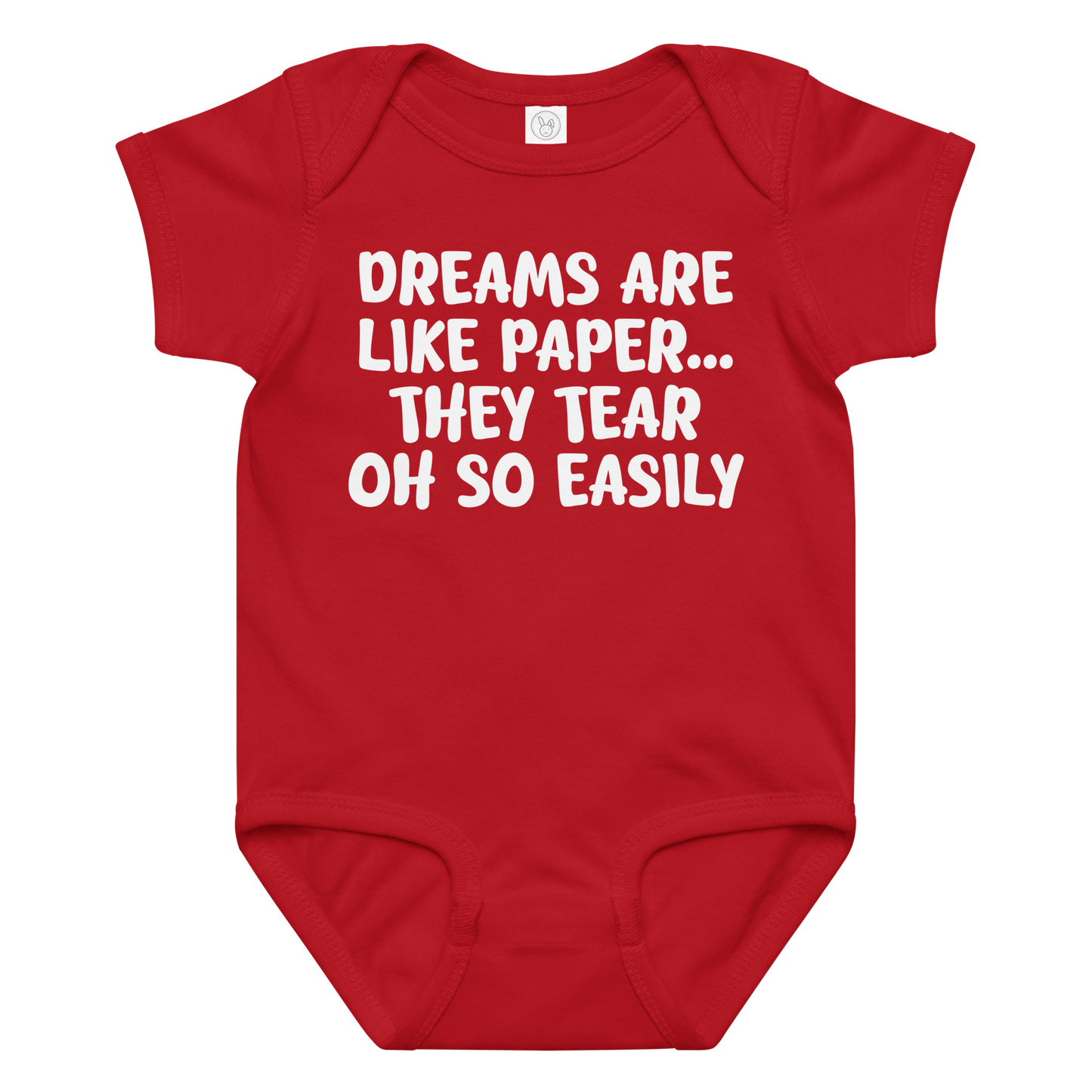 "Dreams are like paper, they tear oh so easily" printed on a red baby jersey bodysuit laying on a flat surface amongst other clothes