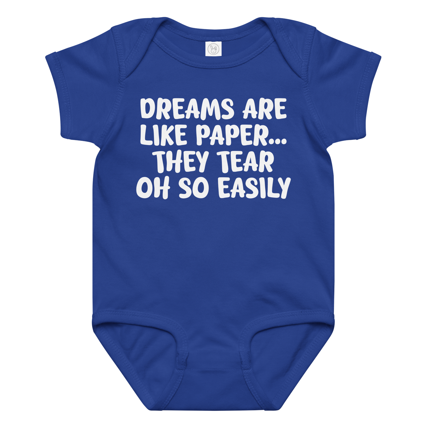 "Dreams are like paper, they tear oh so easily" printed on a royal baby jersey bodysuit laying on a flat surface amongst other clothes