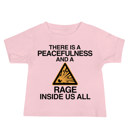 "There is a peacefulness and a rage inside us all" printed on a pink baby jersey short sleeve tee laying on a flat surface