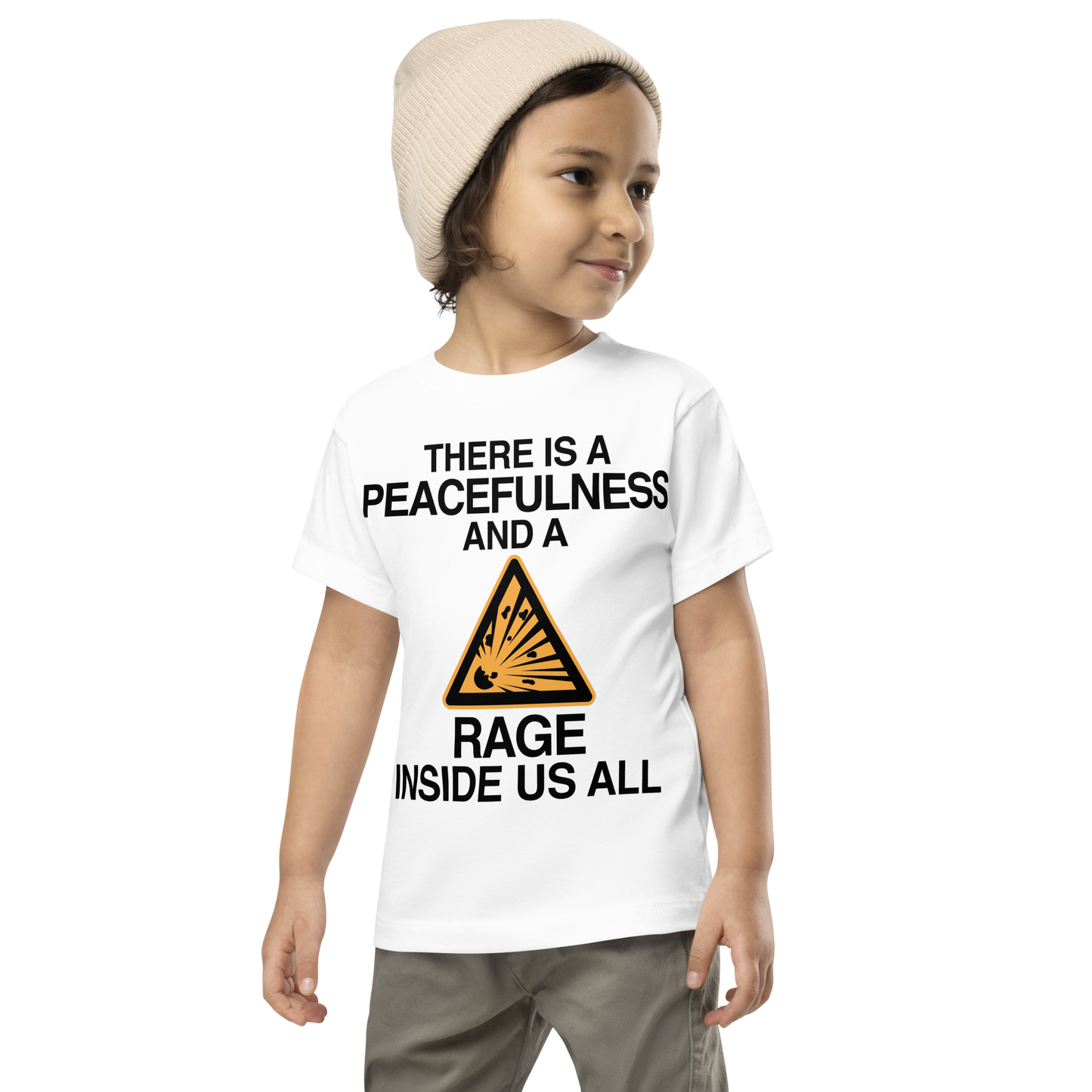 "There is a peacefulness and a rage inside us all" printed on a white toddler short sleeve tee worn by a male wearing a cap