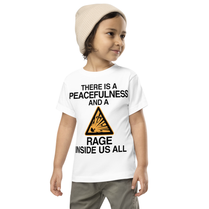 "There is a peacefulness and a rage inside us all" printed on a white toddler short sleeve tee worn by a male wearing a cap