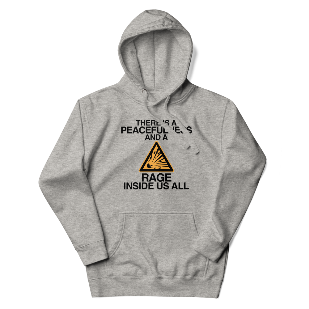 "There is a peacefulness and a rage inside us all" printed on a carbon grey unisex hoodie laying on a flat surface with the hood up