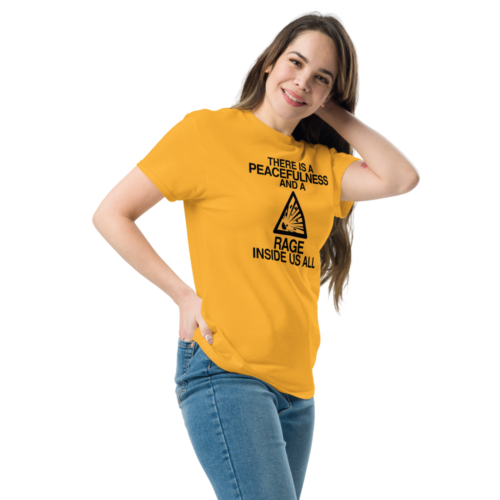 "There is a peacefulness and a rage inside us all" printed on a gold unisex classic tee worn by a female