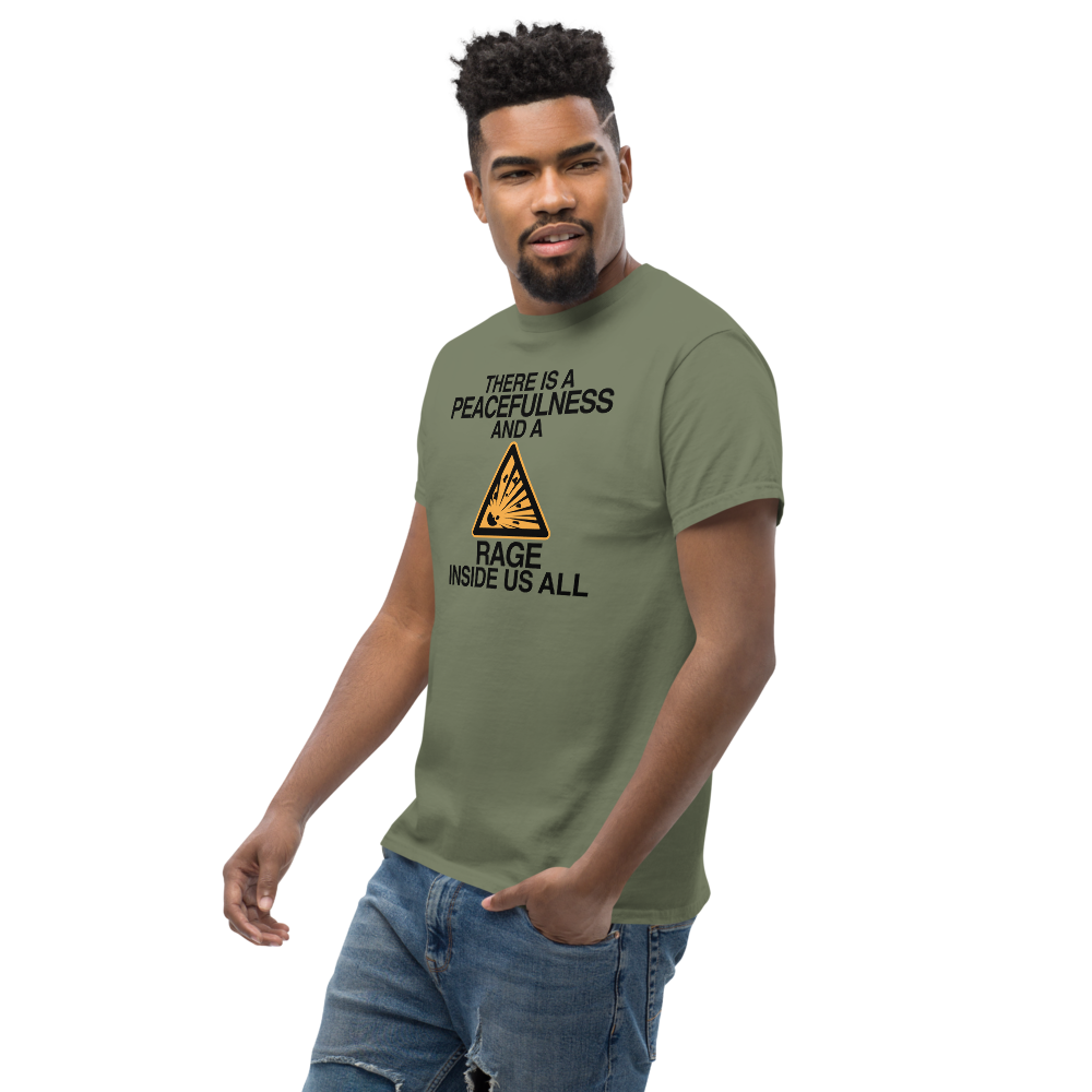 "There is a peacefulness and a rage inside us all" printed on a military green unisex classic tee worn by a male