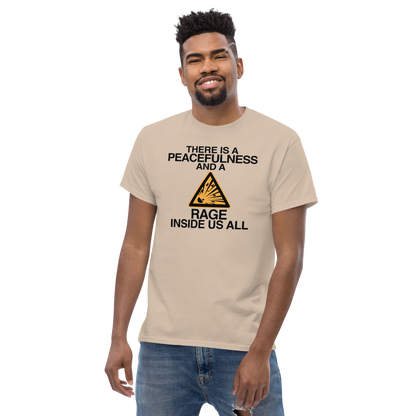 "There is a peacefulness and a rage inside us all" printed on a sand unisex classic tee worn by a male