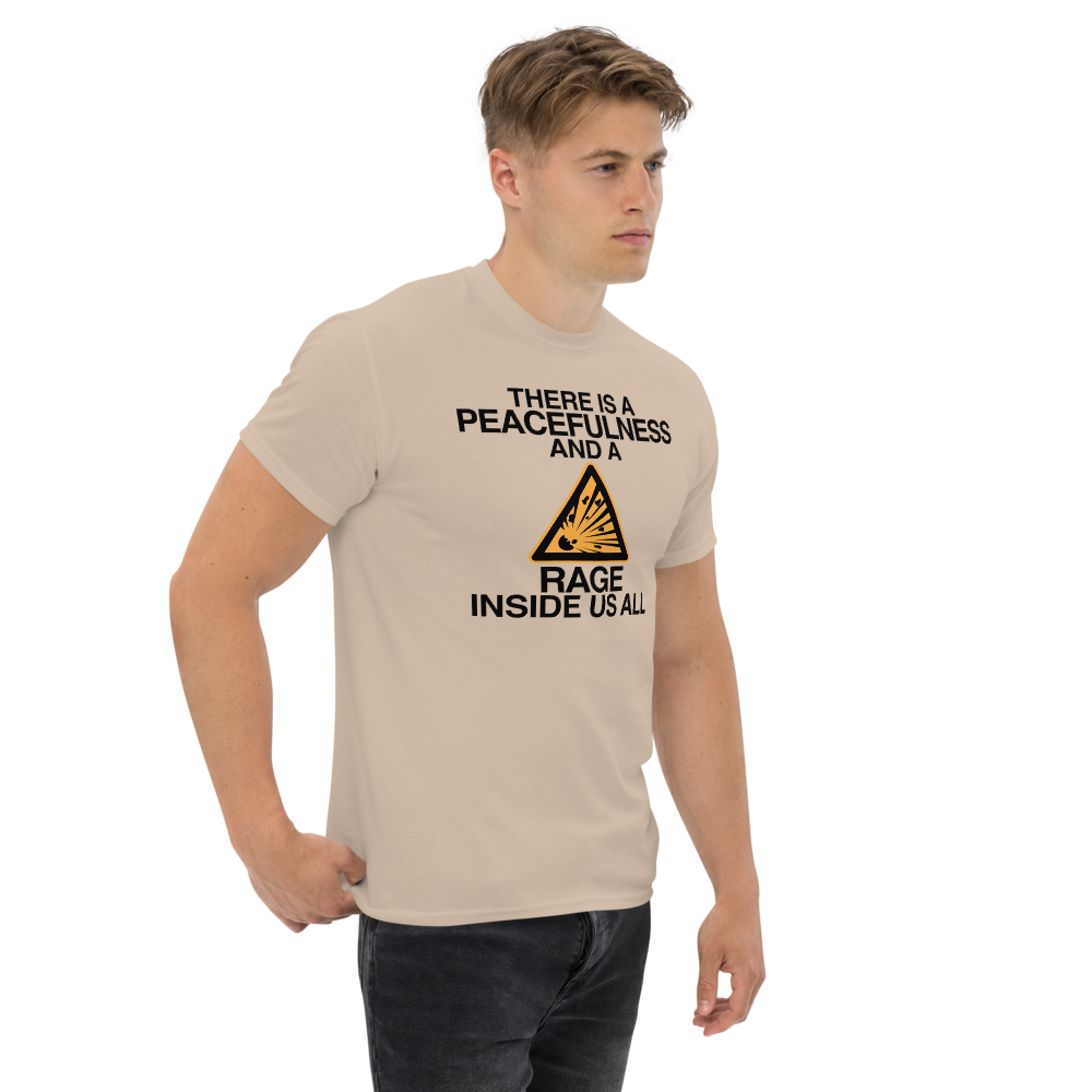 "There is a peacefulness and a rage inside us all" printed on a sand unisex classic tee worn by a male