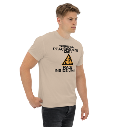 "There is a peacefulness and a rage inside us all" printed on a sand unisex classic tee worn by a male