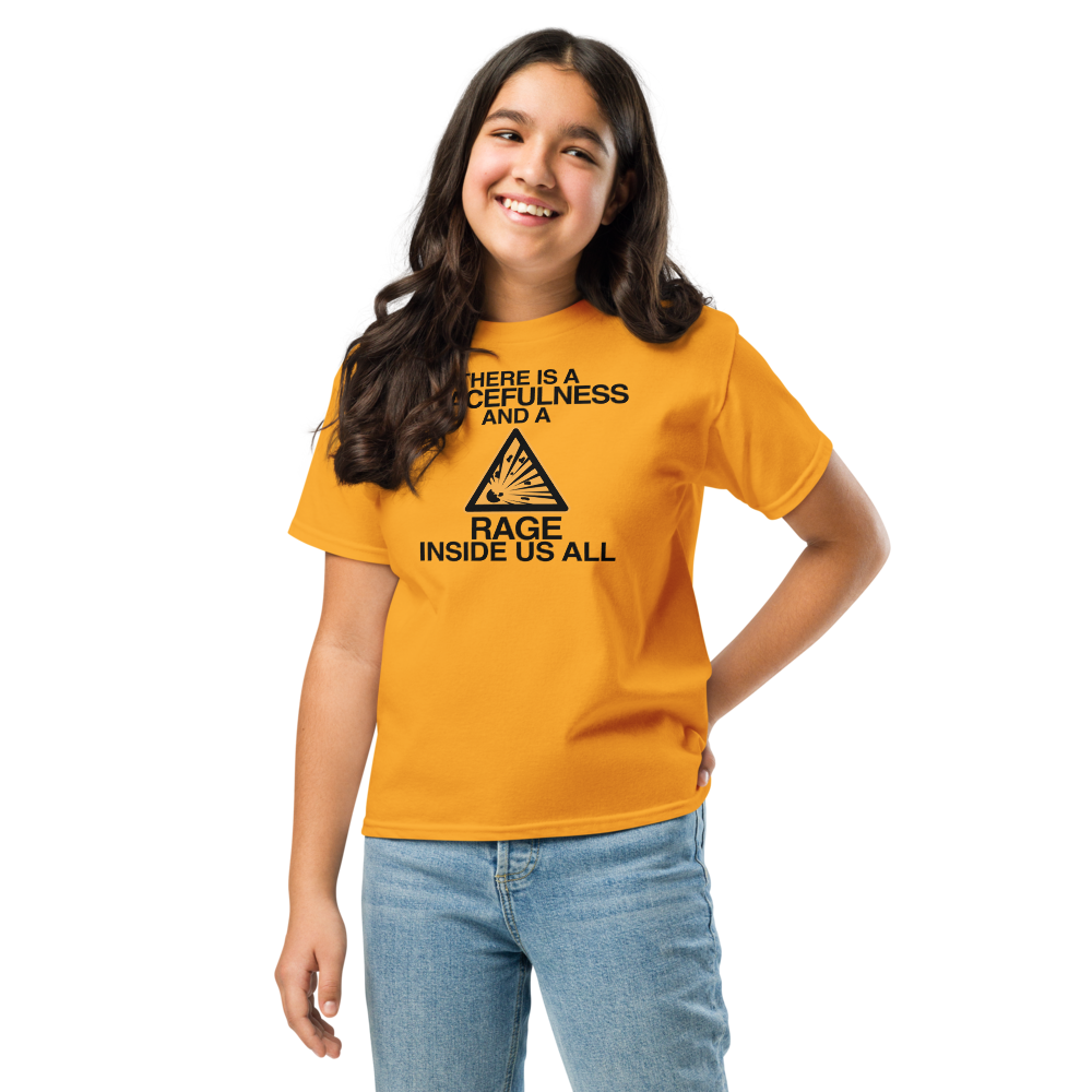 "There is a peacefulness and a rage inside us all" printed on a gold youth classic tee worn by a female