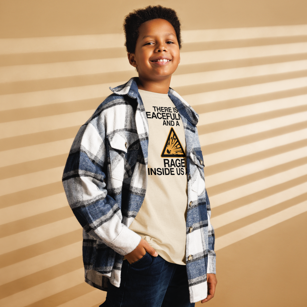 "There is a peacefulness and a rage inside us all" printed on a natural youth classic tee worn by a male also wearing a jacket