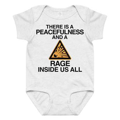 "There is a peacefulness and a rage inside us all" printed on a ash baby jersey bodysuit laying on a flat surface amongst other clothes