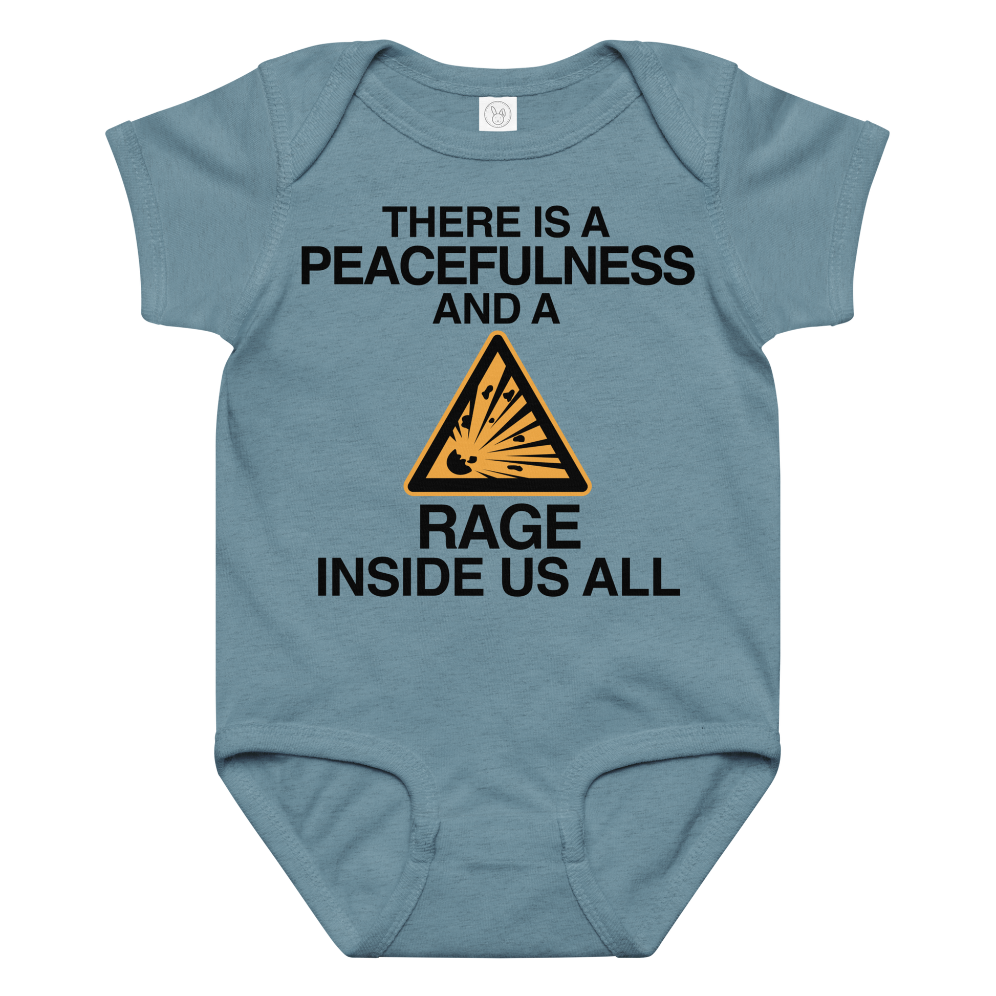 "There is a peacefulness and a rage inside us all" printed on a vintage indigo baby jersey bodysuit laying on a flat surface amongst other clothes