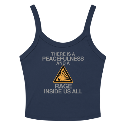 "There is a peacefulness and a rage inside us all" printed on a solid navy blend women's micro-rib tanktop laying on a flat surface amongst sunglasses and shorts