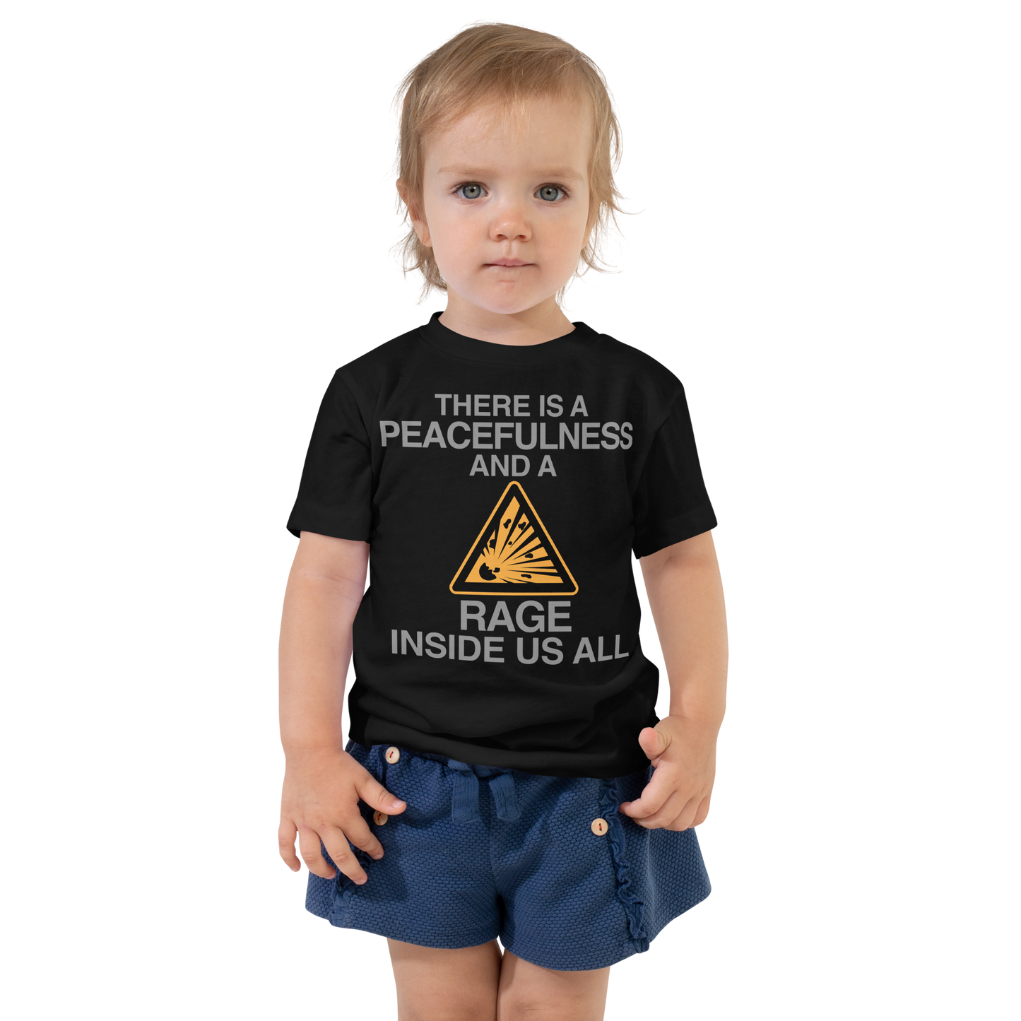 "There is a peacefulness and a rage inside us all" printed on a black toddler short sleeve tee worn by a female