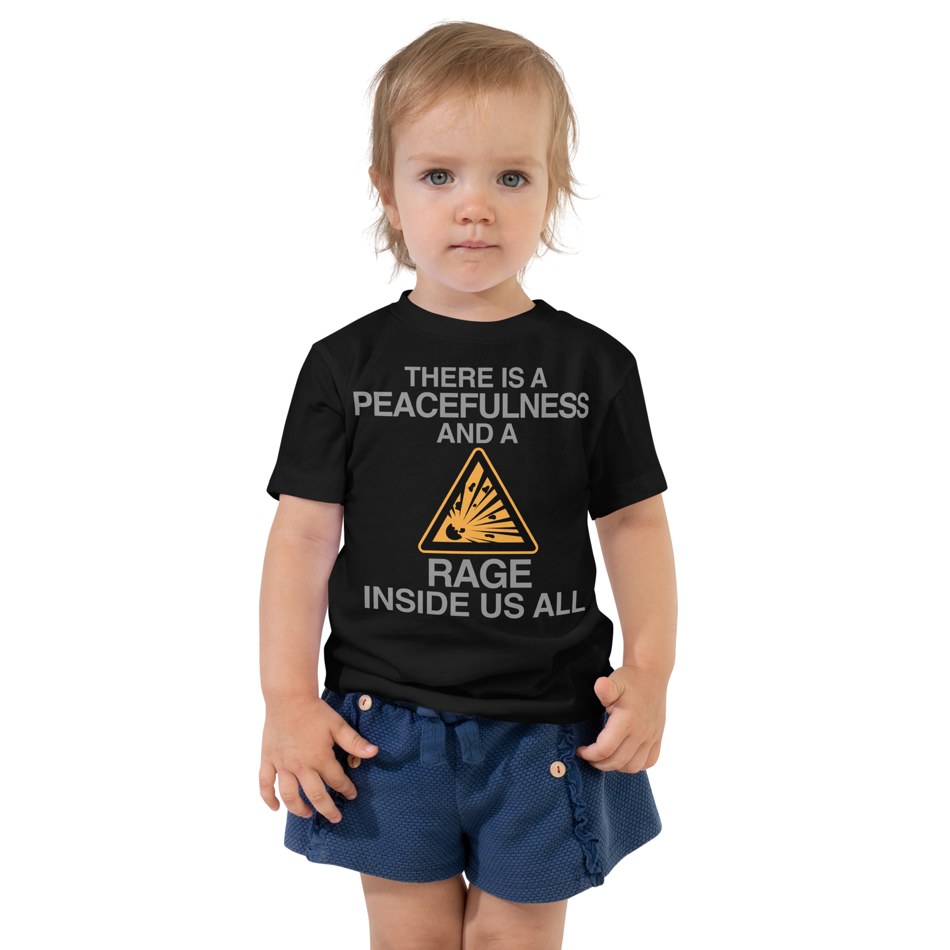 "There is a peacefulness and a rage inside us all" printed on a black toddler short sleeve tee worn by a female
