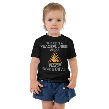 "There is a peacefulness and a rage inside us all" printed on a black toddler short sleeve tee worn by a female