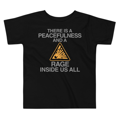 "There is a peacefulness and a rage inside us all" printed on a black toddler short sleeve tee laying on a flat surface