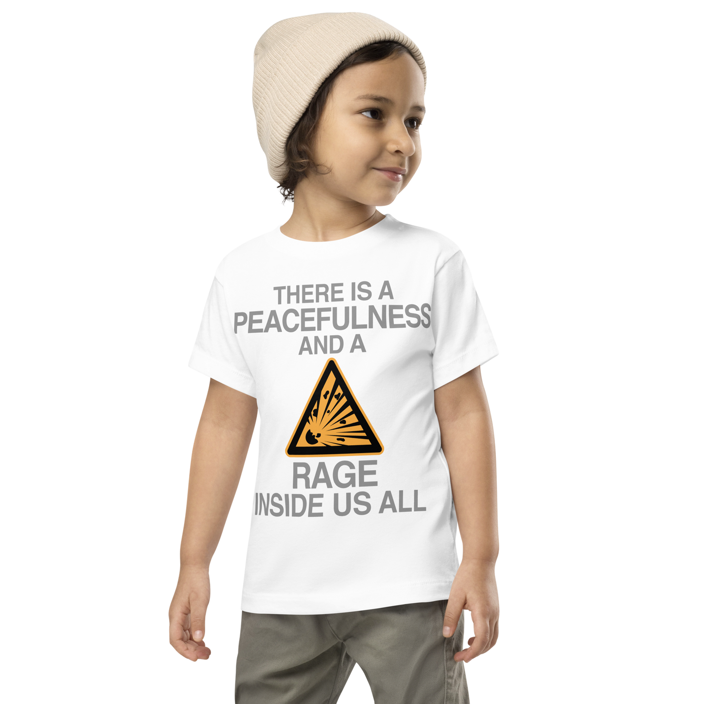 "There is a peacefulness and a rage inside us all" printed on a white toddler short sleeve tee worn by a male wearing a cap