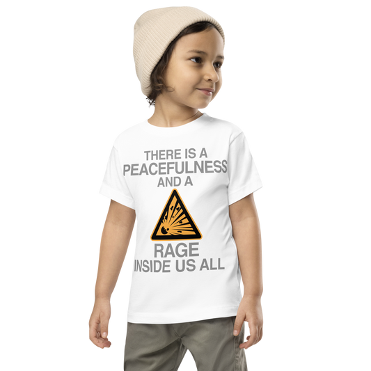"There is a peacefulness and a rage inside us all" printed on a white toddler short sleeve tee worn by a male wearing a cap