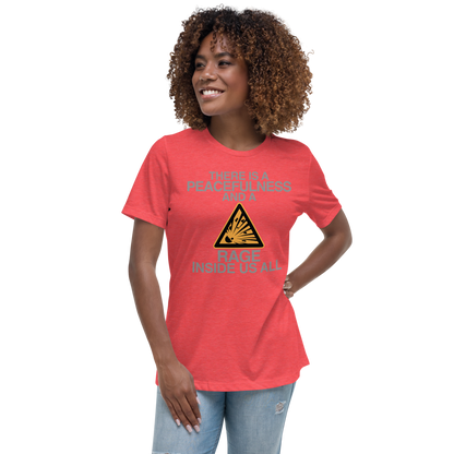 "There is a peacefulness and a rage inside us all" printed on a heather red women's relaxed t-shirt worn by a female