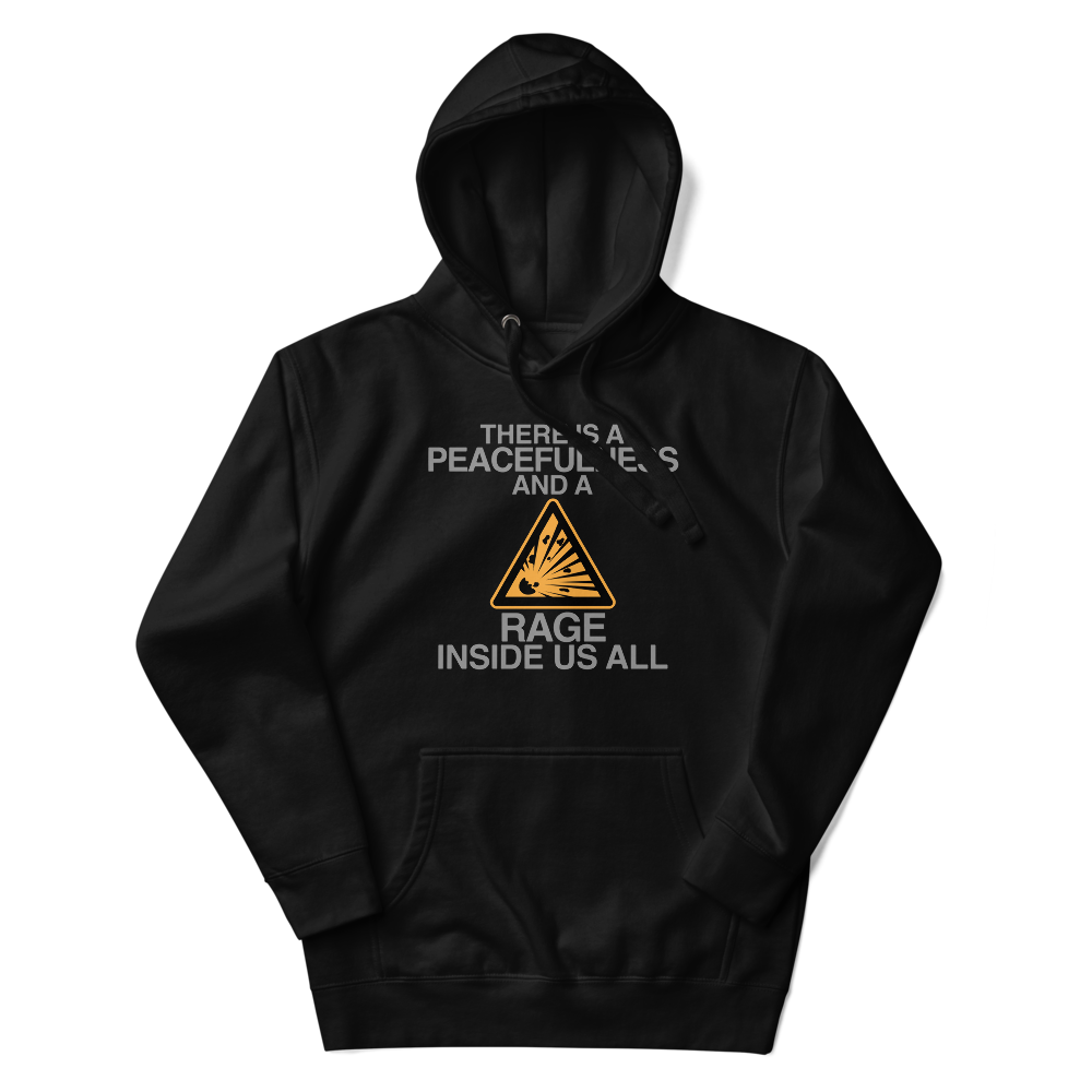 "There is a peacefulness and a rage inside us all" printed on a black unisex hoodie laying on a flat surface with the hood up