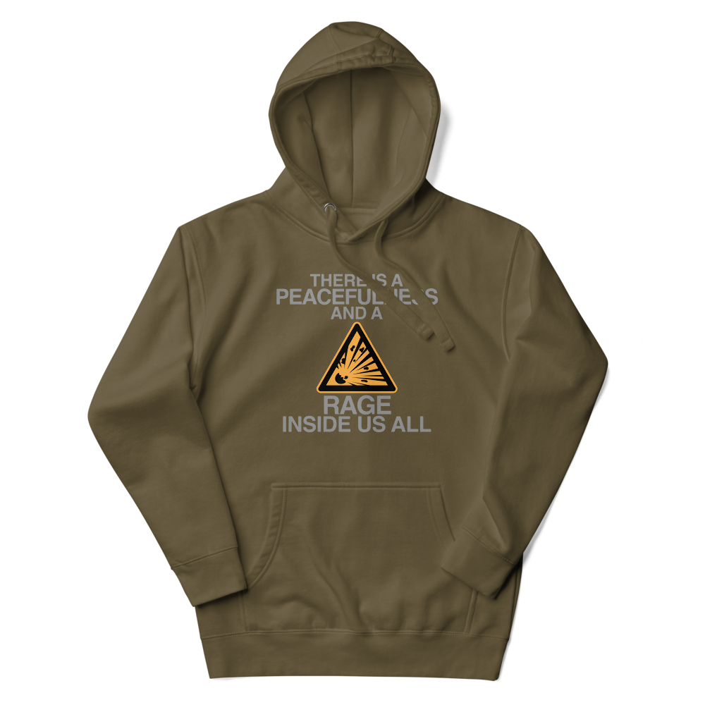 "There is a peacefulness and a rage inside us all" printed on a military green unisex hoodie laying on a flat surface with the hood up
