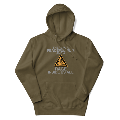 "There is a peacefulness and a rage inside us all" printed on a military green unisex hoodie laying on a flat surface with the hood up