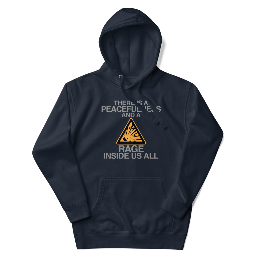 "There is a peacefulness and a rage inside us all" printed on a navy blazer unisex hoodie laying on a flat surface with the hood up